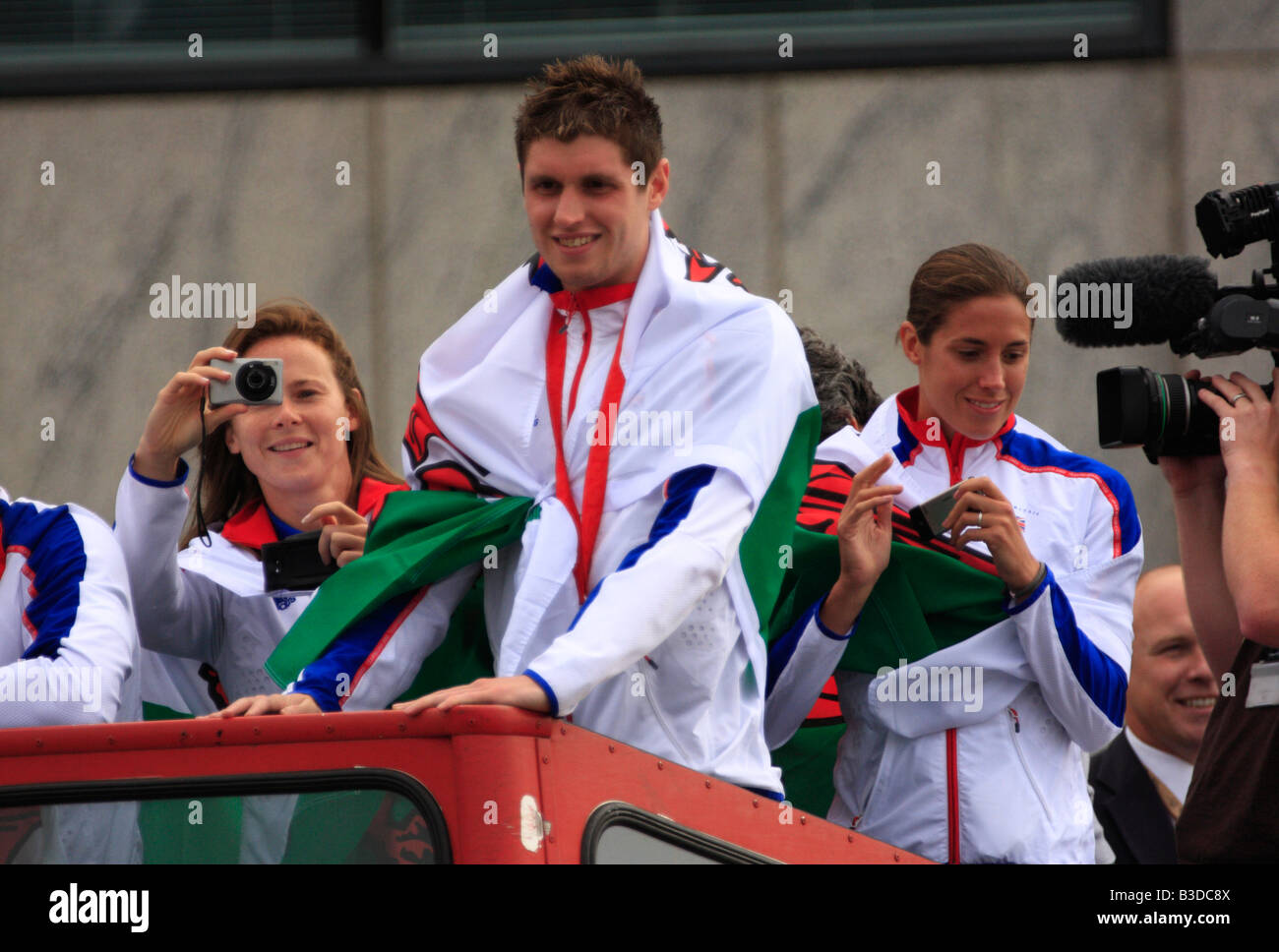 Welsh Olympic Athletes, Sarah Thomas, David Davies, and Helen Tucker, on an open top bus ride in Cardiff Bay Stock Photo