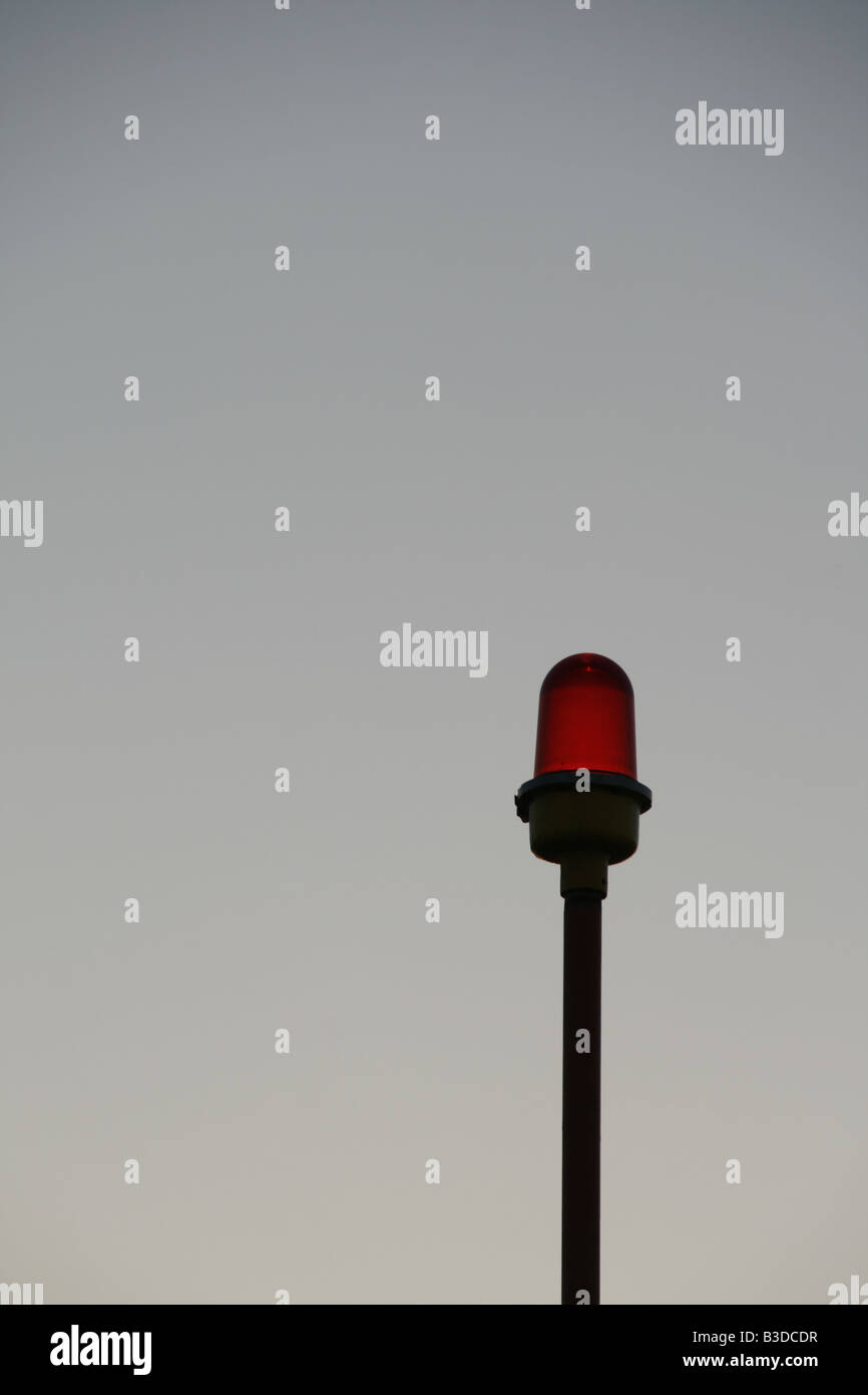 one red security light on property at night Stock Photo Alamy