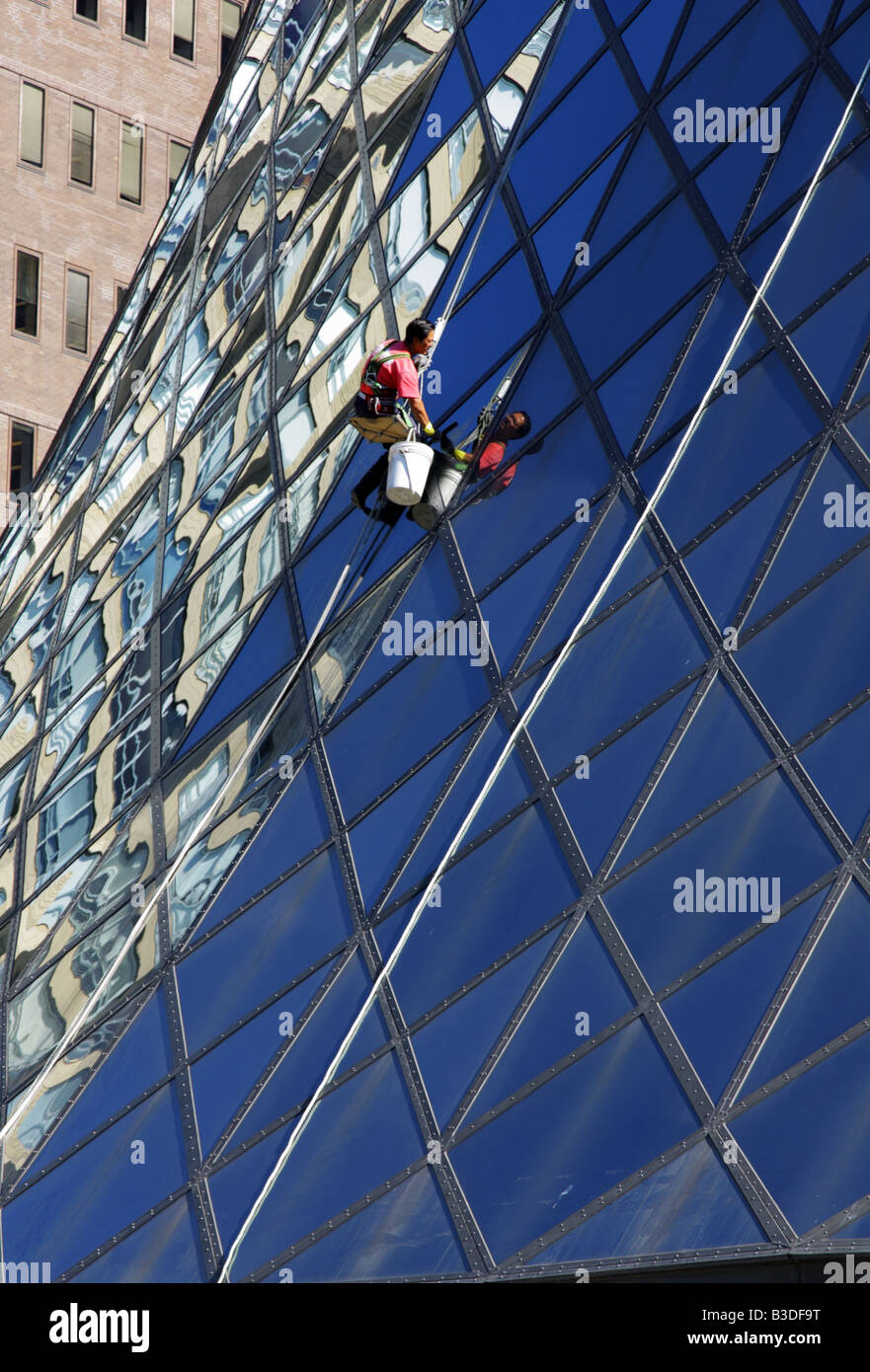 Window cleaner washing the glass dome of Roy Thompson Hall in Toronto Stock Photo