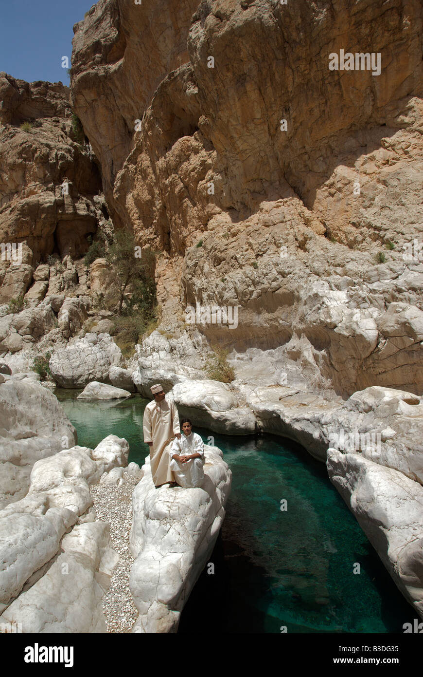Two men in traditional clothes Wadi Bani Khalid Pools Sharqiya Region Oman Stock Photo