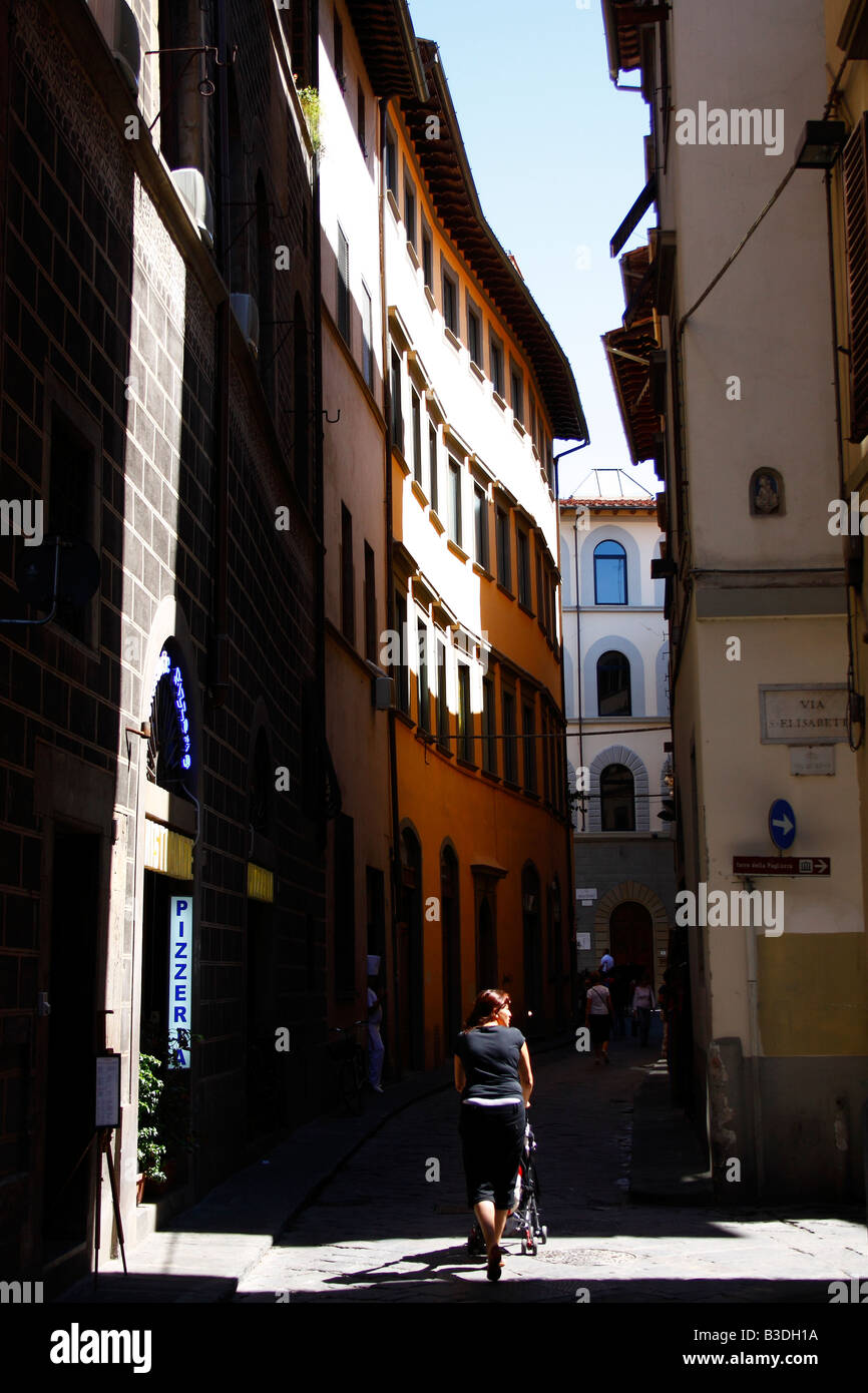 A woman is walking arround in the streets of Florence with her baby in the buggy (stroller). Tuscan (Tuscany) Florence, Italy Stock Photo