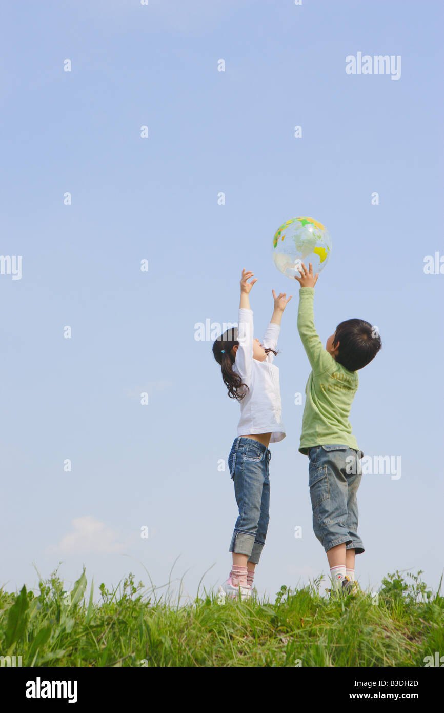 Children playing with ball in park Stock Photo