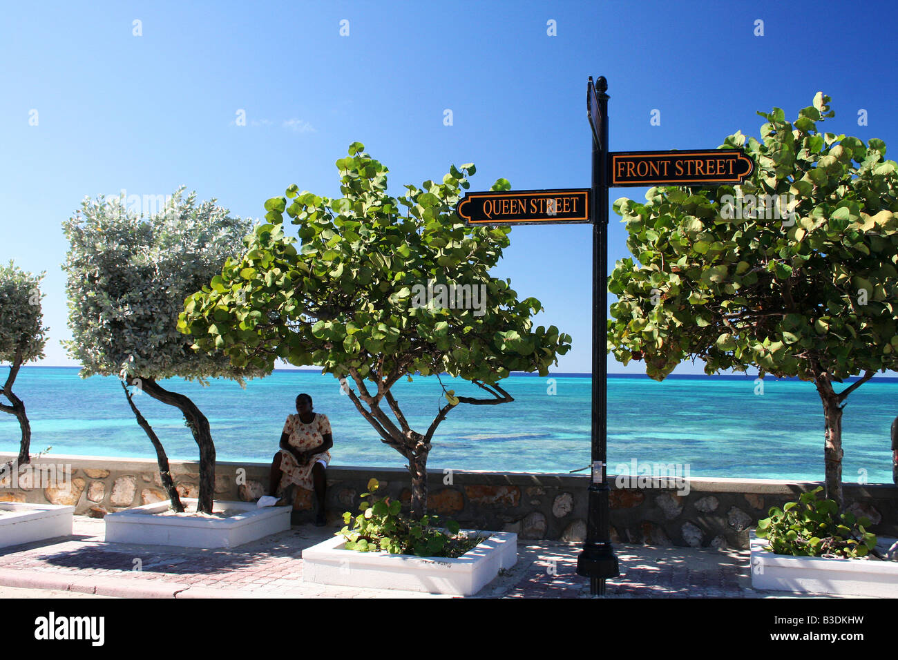 Sitting under a shady tree on Front Street, Cockburn Town, Turks and Caicos Islands Stock Photo