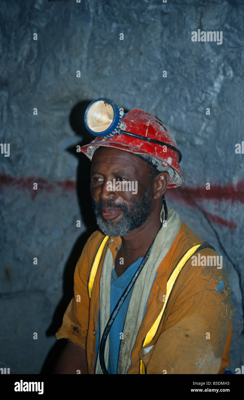 Diamond miner wearing hard hat and head torch in diamond mine, South