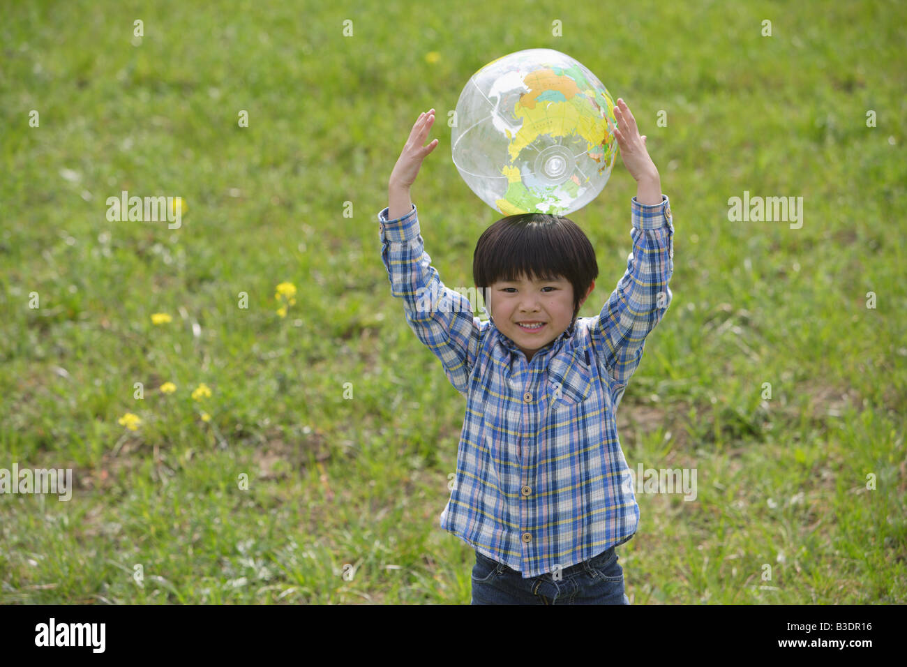 Boy playing with a ball in park Stock Photo - Alamy