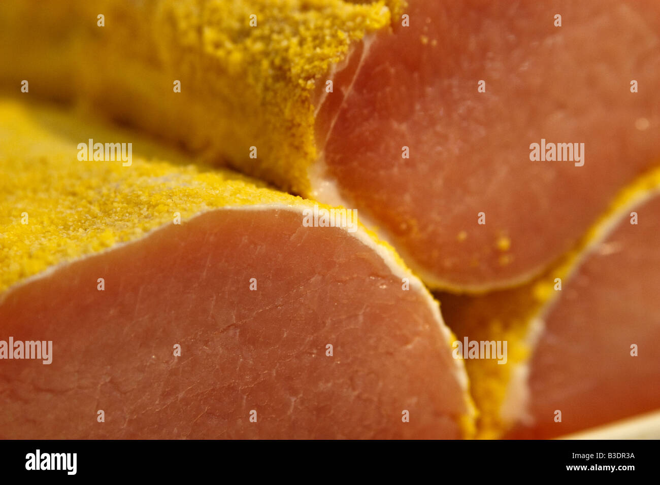 Peameal bacon closeup, pork in peameal corn breading Stock Photo Alamy
