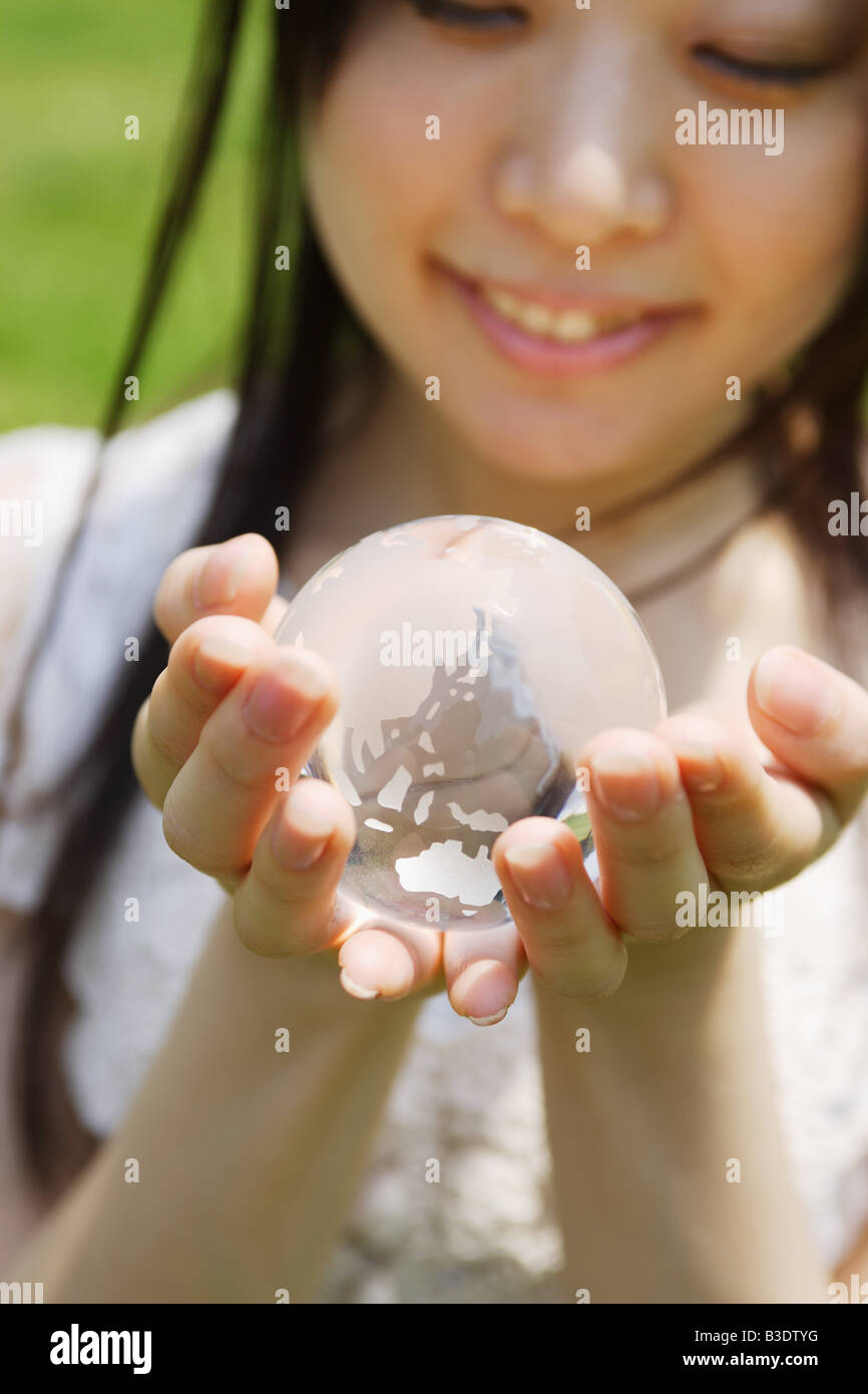 Young woman holding a globe Stock Photo