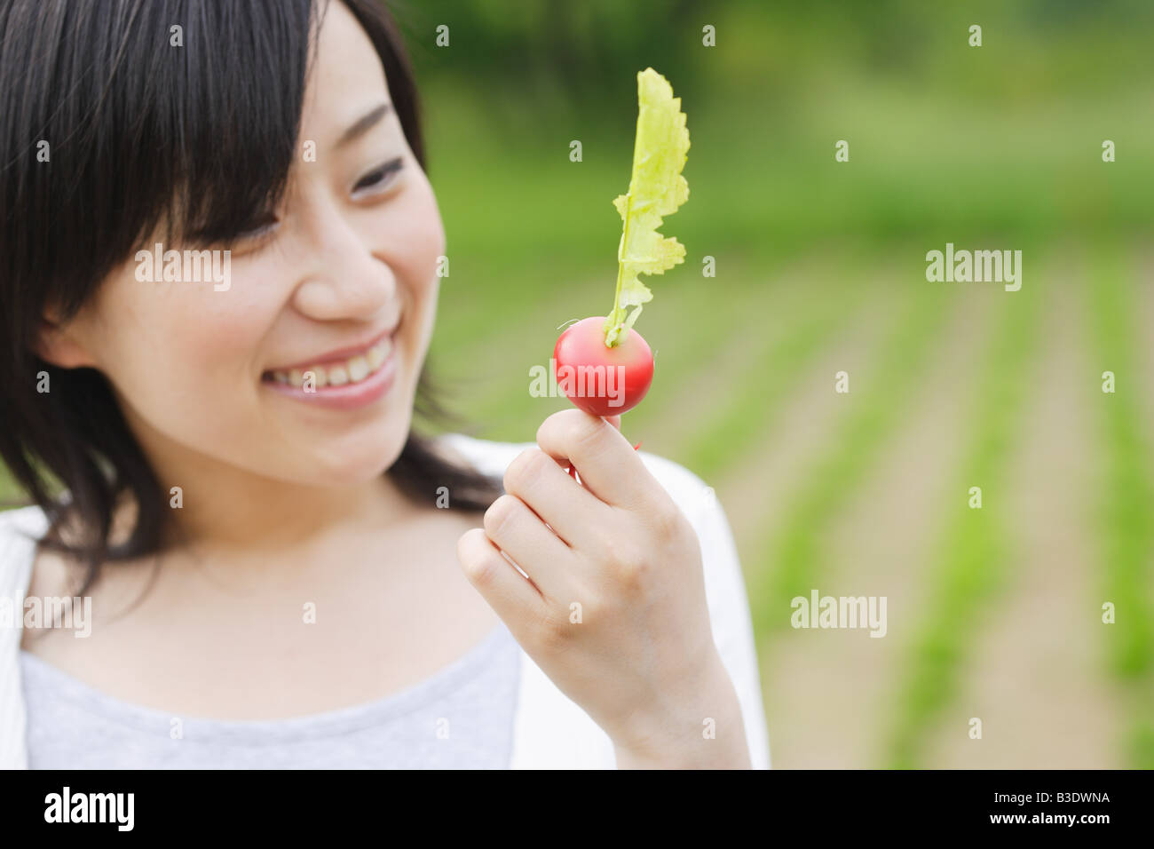 Young smiling woman holding turnip Stock Photo