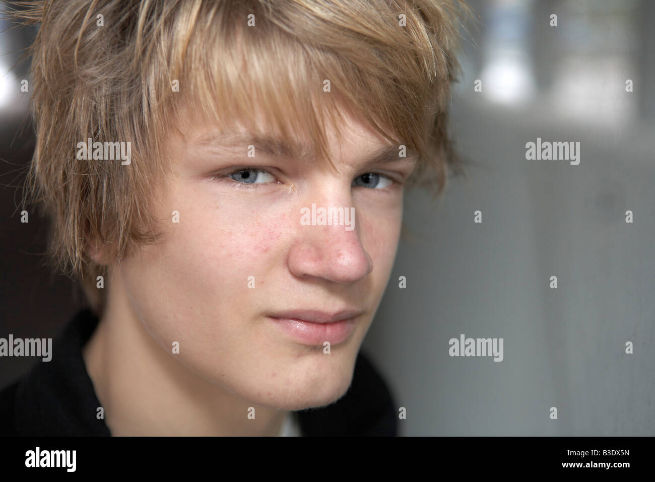Close up of teenage boy looking at camera exterior Stock Photo - Alamy