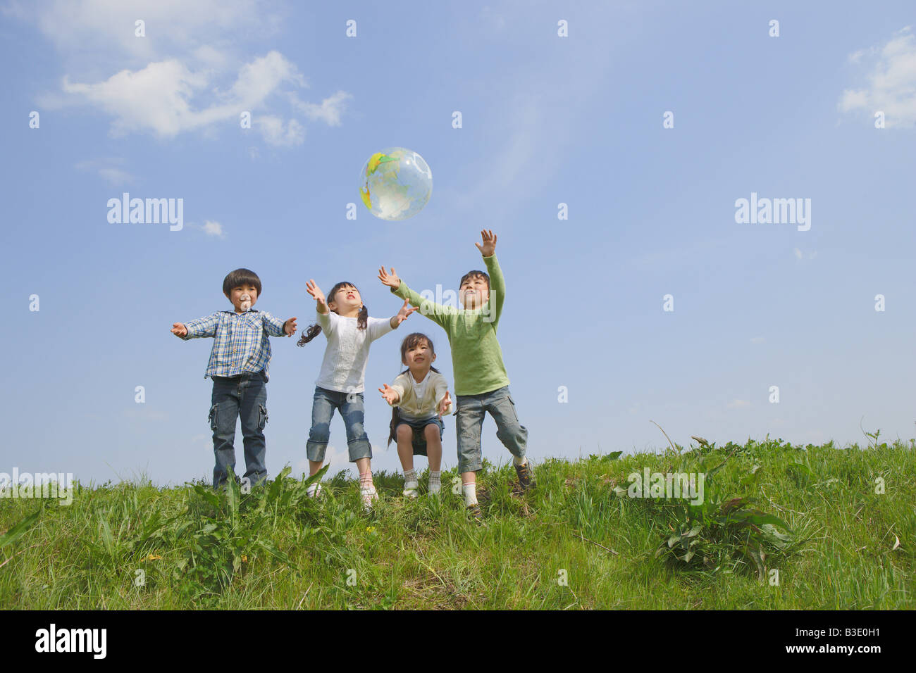 Children playing in park together Stock Photo