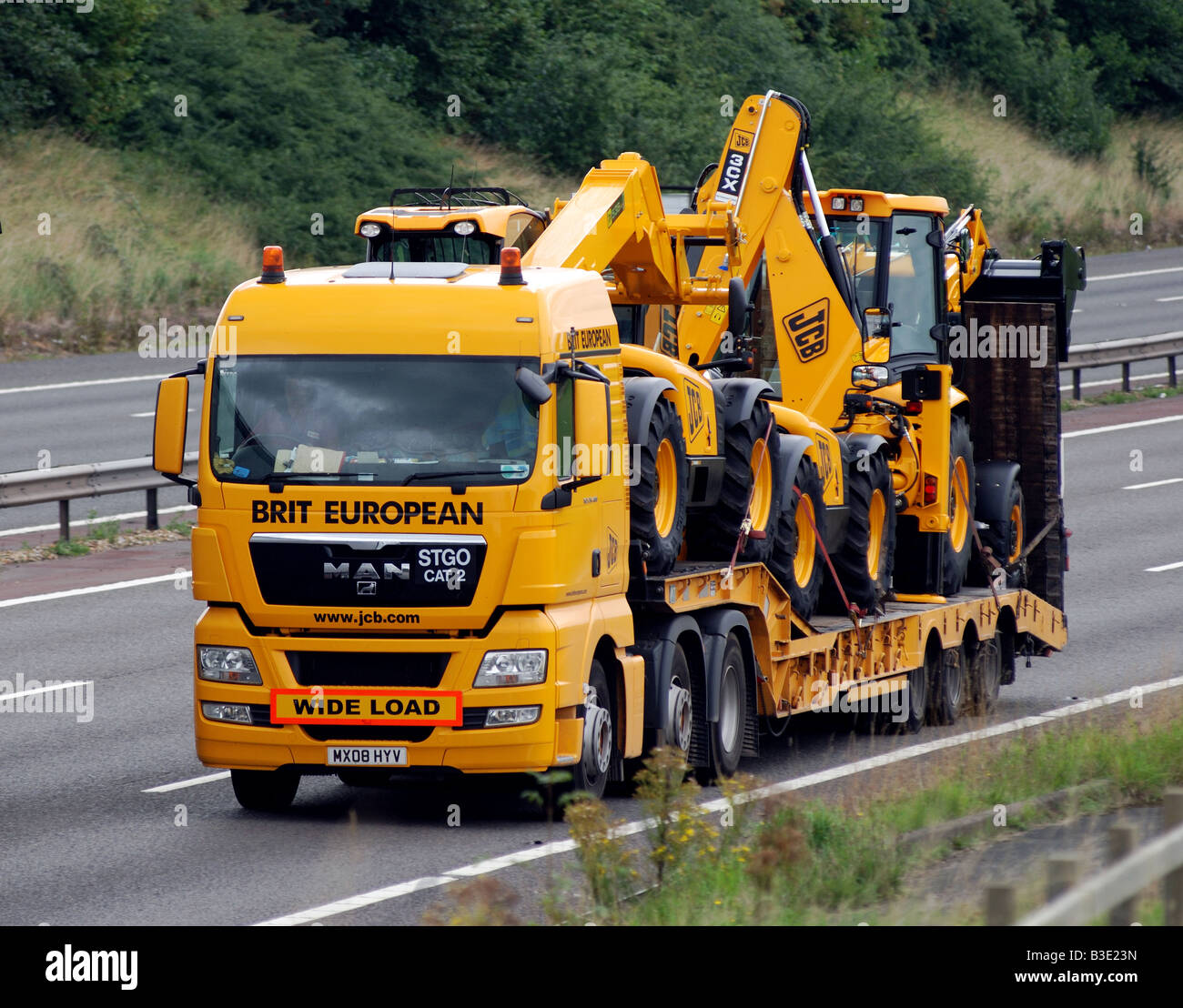 New JCB vehicles transported on M40 motorway, England, UK Stock Photo