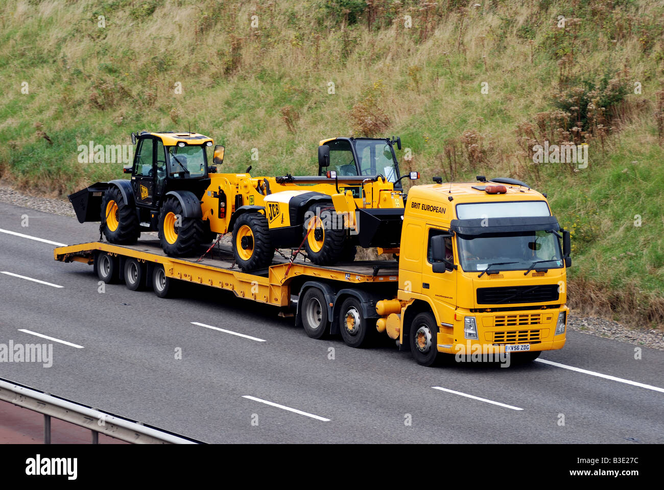New JCB vehicles transported on M40 motorway England UK Stock Photo