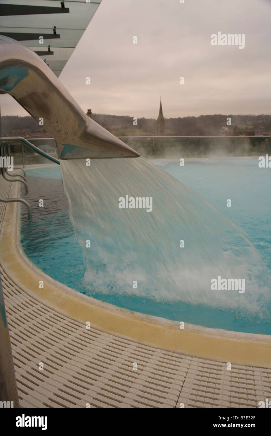 Fountain tap gushing water into a swimming pool. Stock Photo