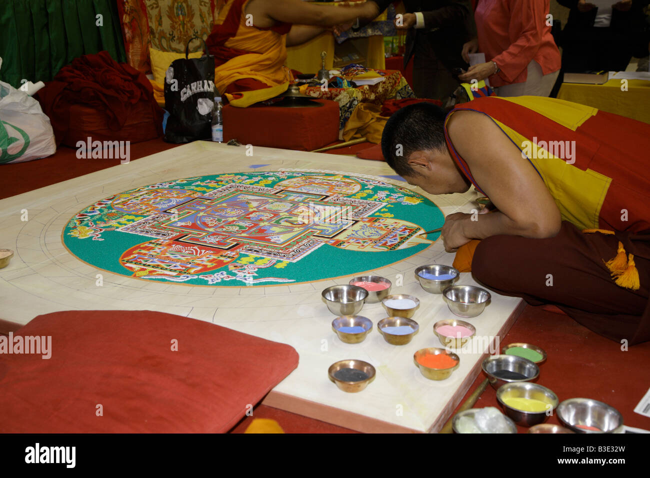 Tibetan monk drawing sand mandala painting Stock Photo