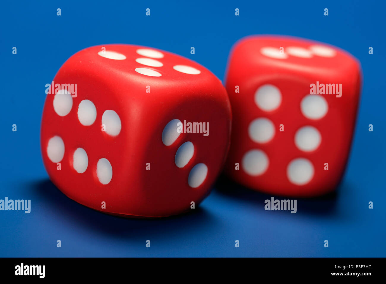 two red dice blue background gaming gambling bet casino plaything pledge addiction easy money Stock Photo