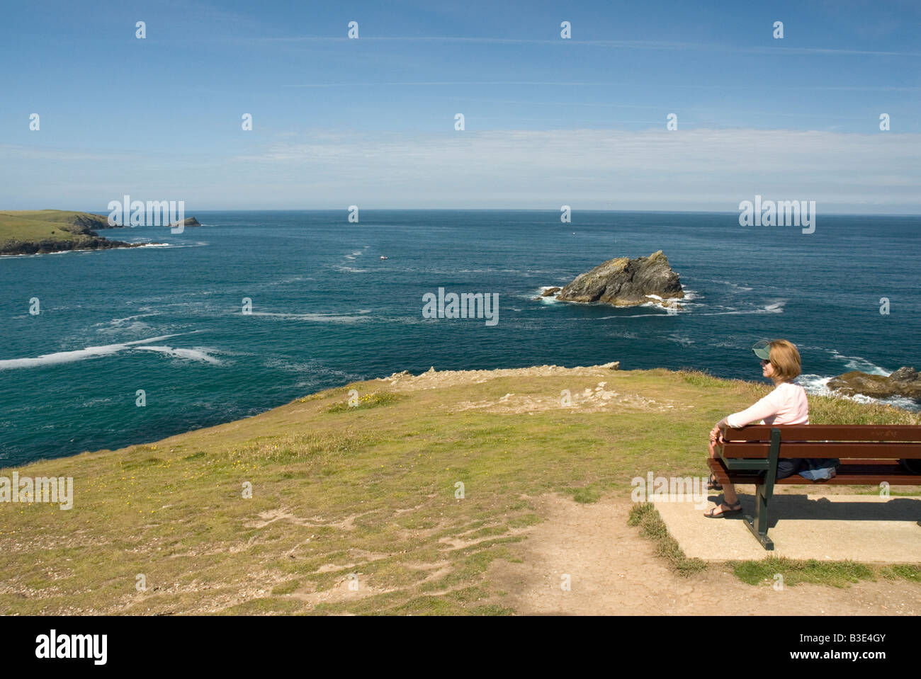 Woman on headland Pentire Point East looking towards The Goose off