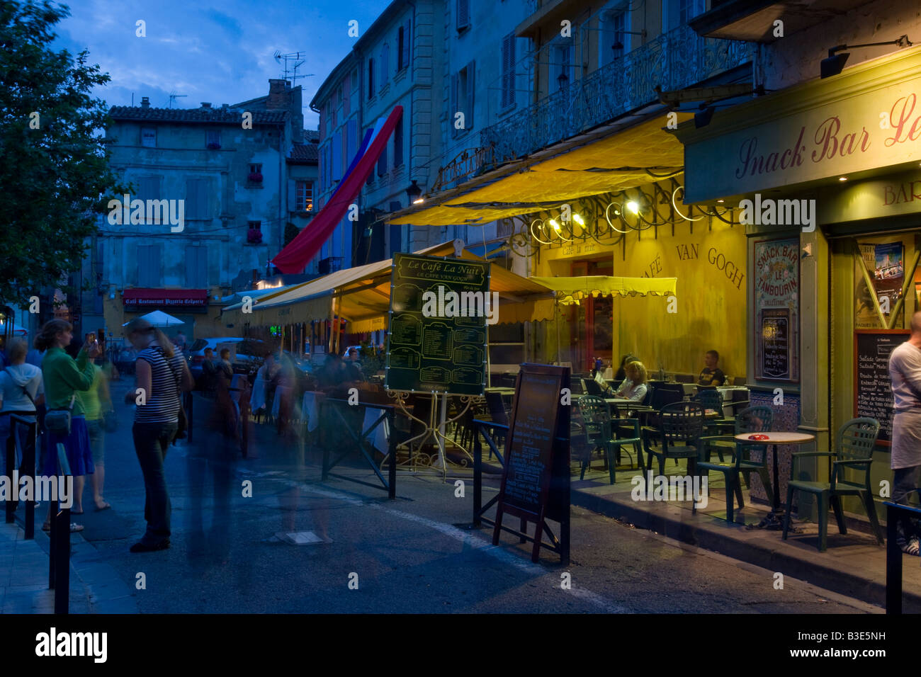 Street and cafe scene at night in Arles France Stock Photo