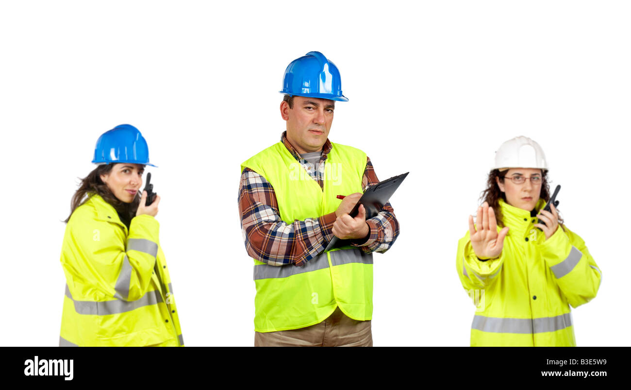 Three construction workers talking with a walkie talkie over a white background Focus at front Stock Photo