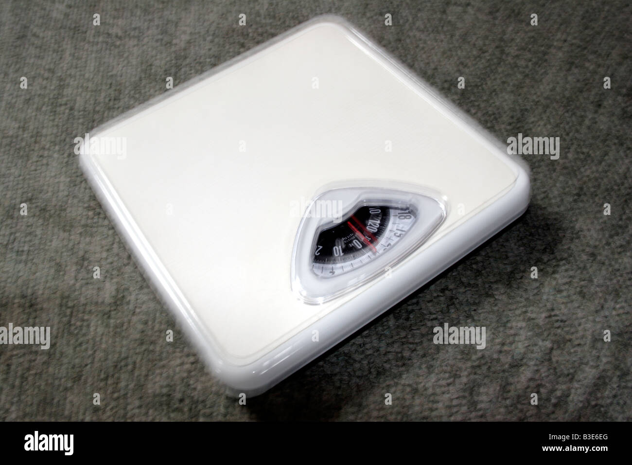 Weighing scales on carpet close up Stock Photo Alamy