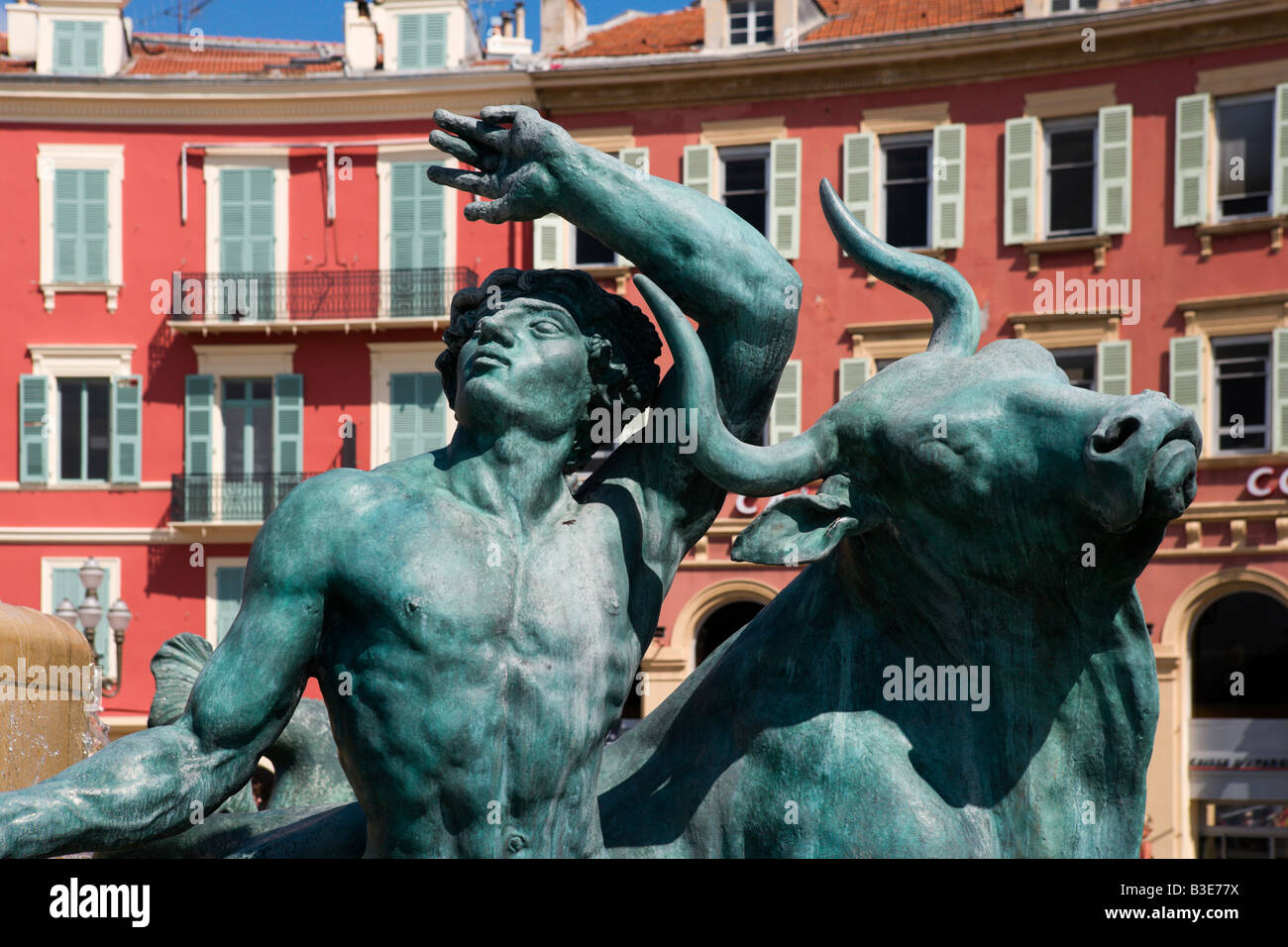 Statue on a fountain with Italianate buildings behind, Place Massena, Nice, Cote d'Azur, French Riviera, France Stock Photo