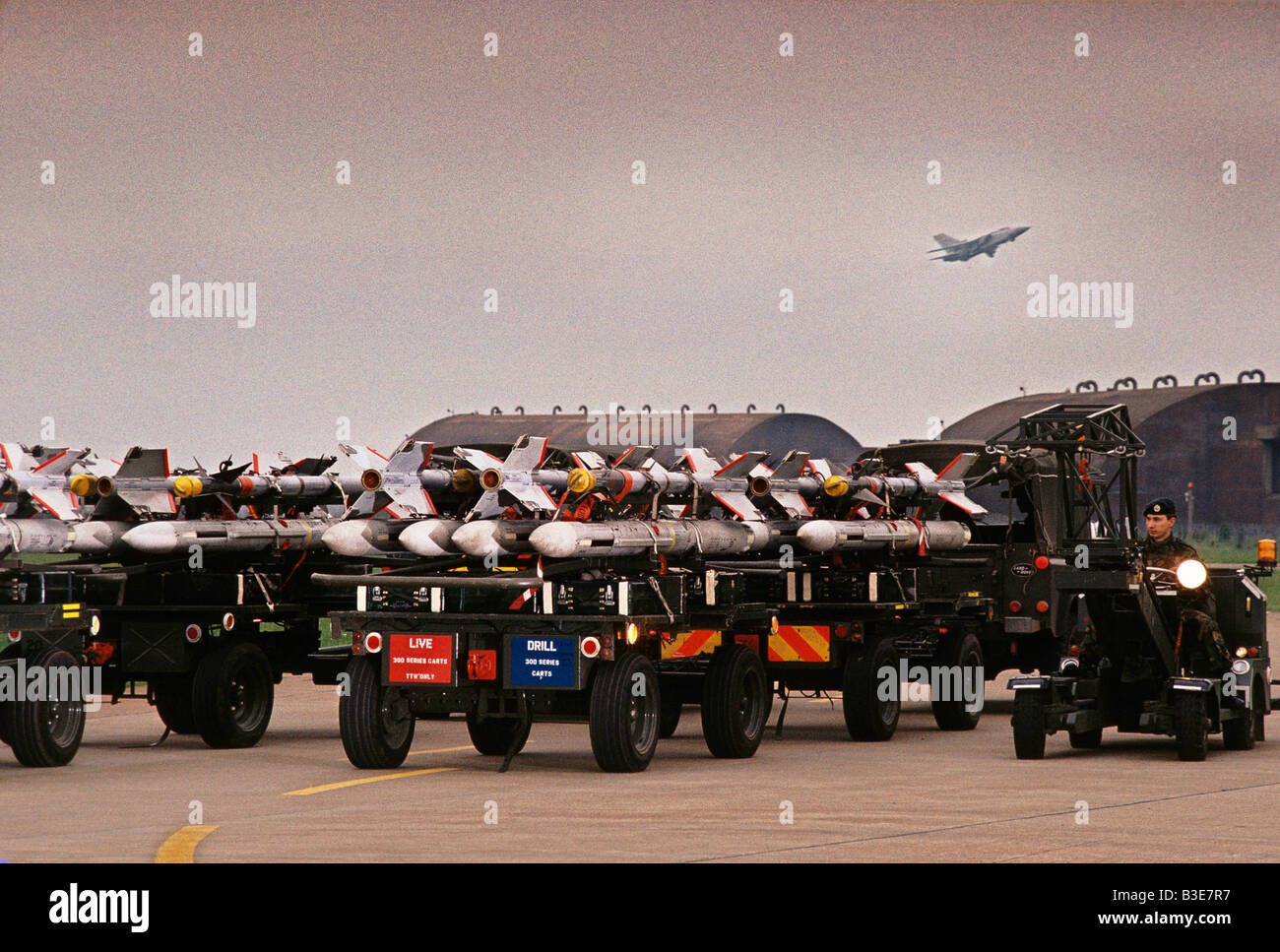 NEXT BATTLE OF BRITAIN GROUND CREW LOADING MISSILES ON TO PHANTOM FIGHTER JETS AT RAF WATTISHAM 1988 Stock Photo