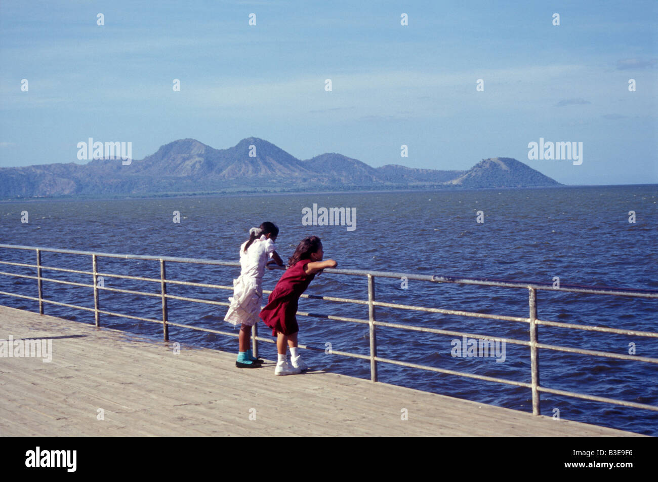 Two girls gazing at Lake Managua on the Malecón in Managua, Nicaragua Stock Photo