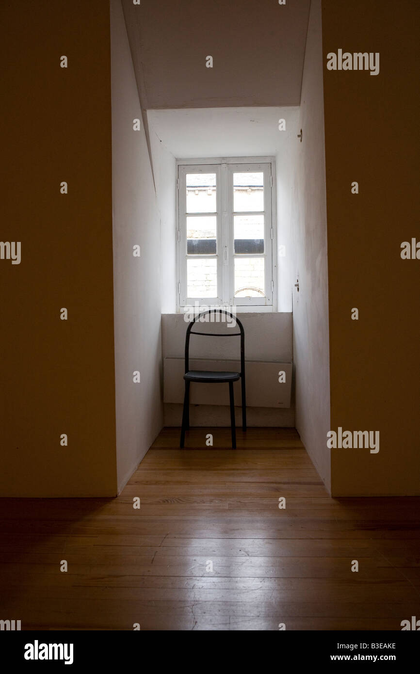 single chair in window Stock Photo - Alamy