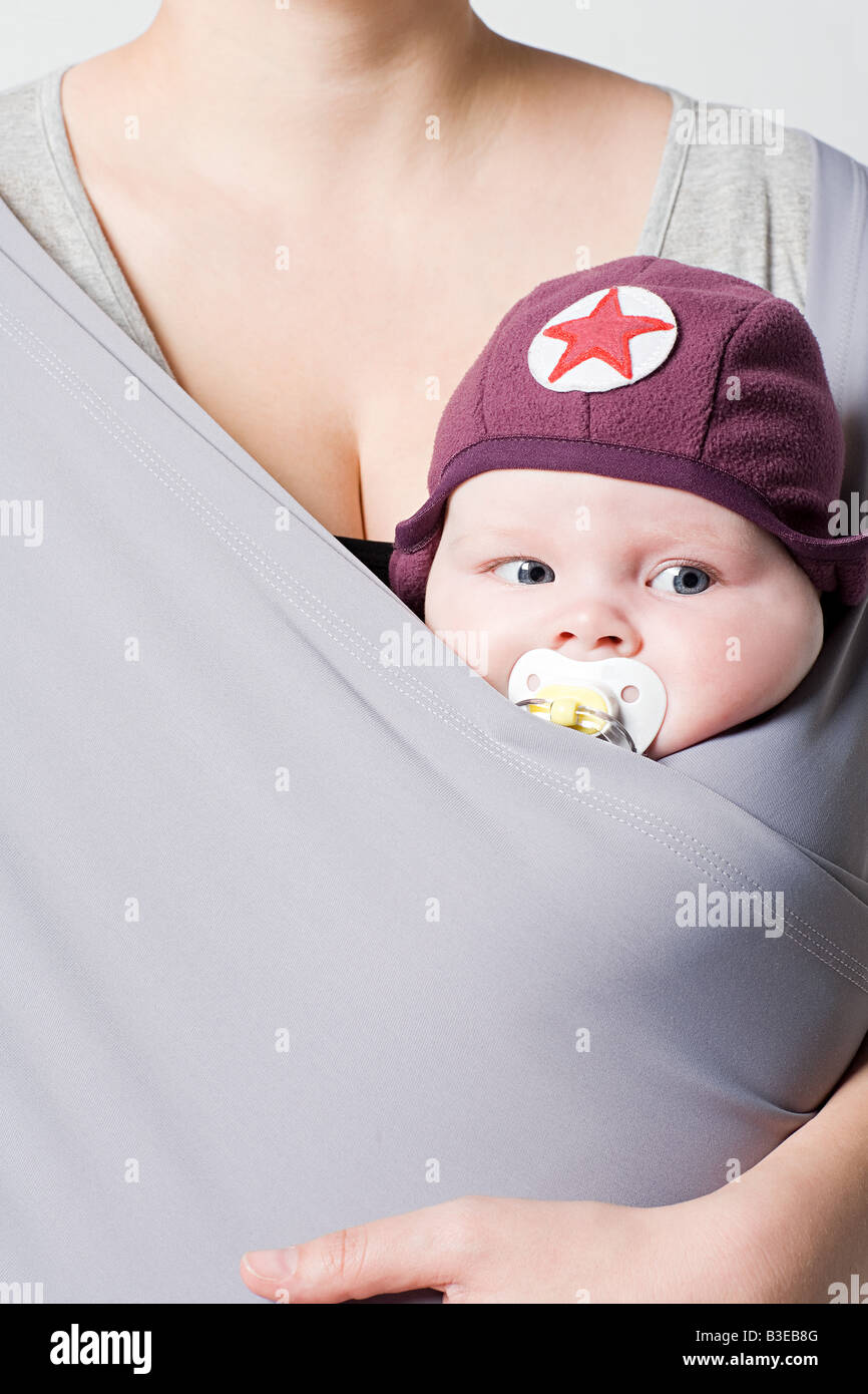A baby in a baby sling Stock Photo Alamy