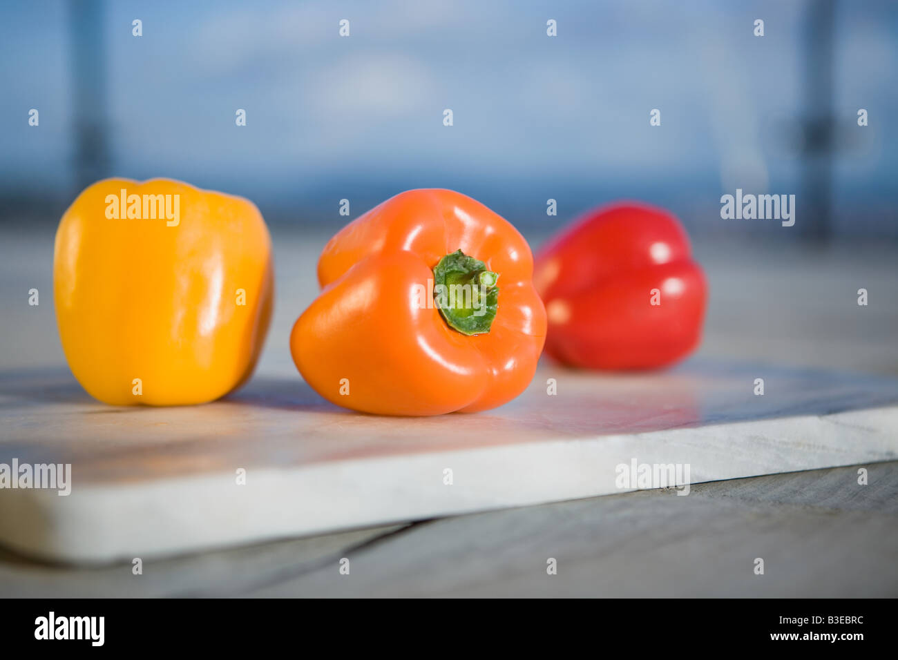 a group of red bell peppers on a white background Stock Photo - Alamy
