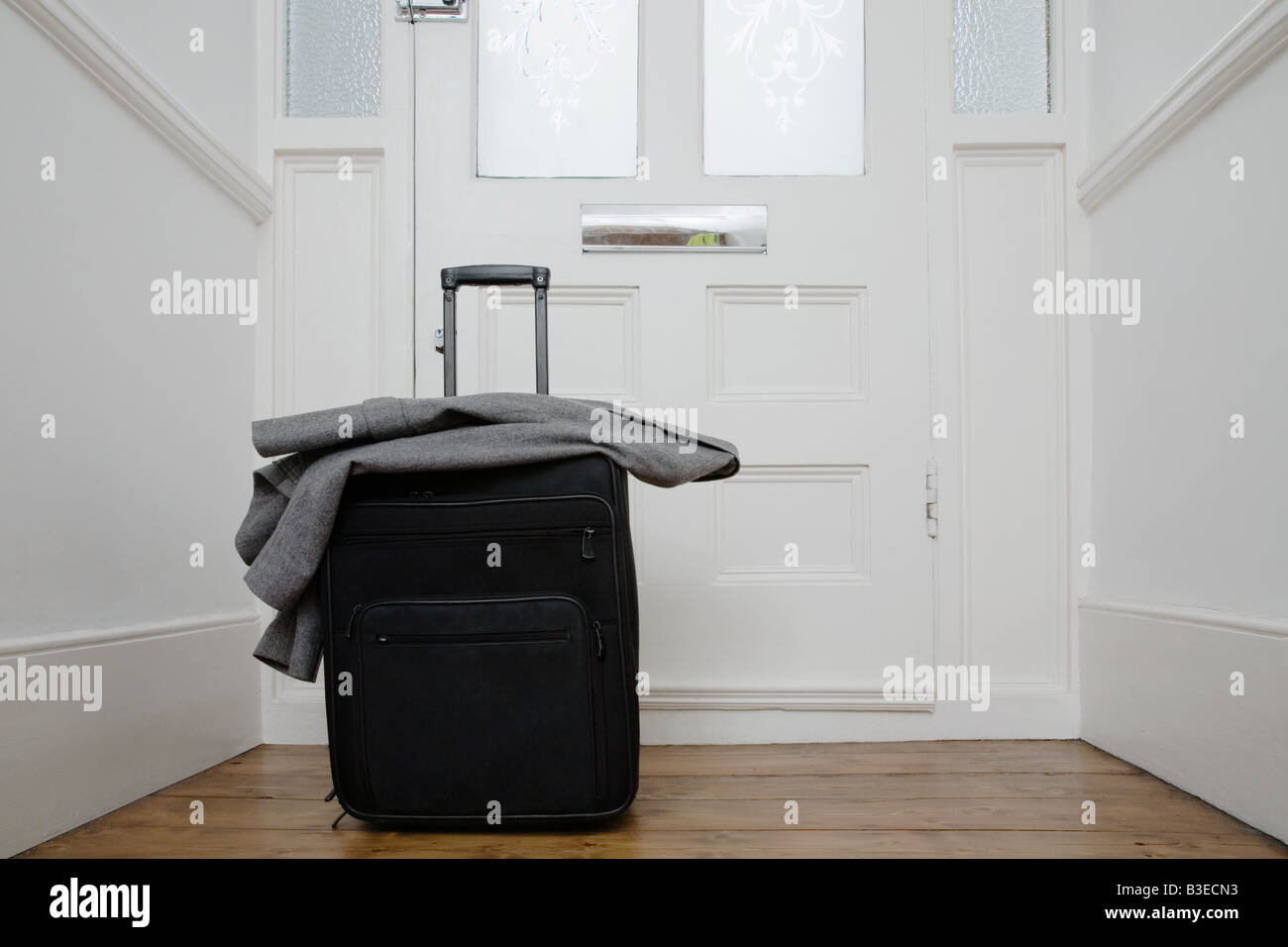 Suitcase by front door Stock Photo Alamy