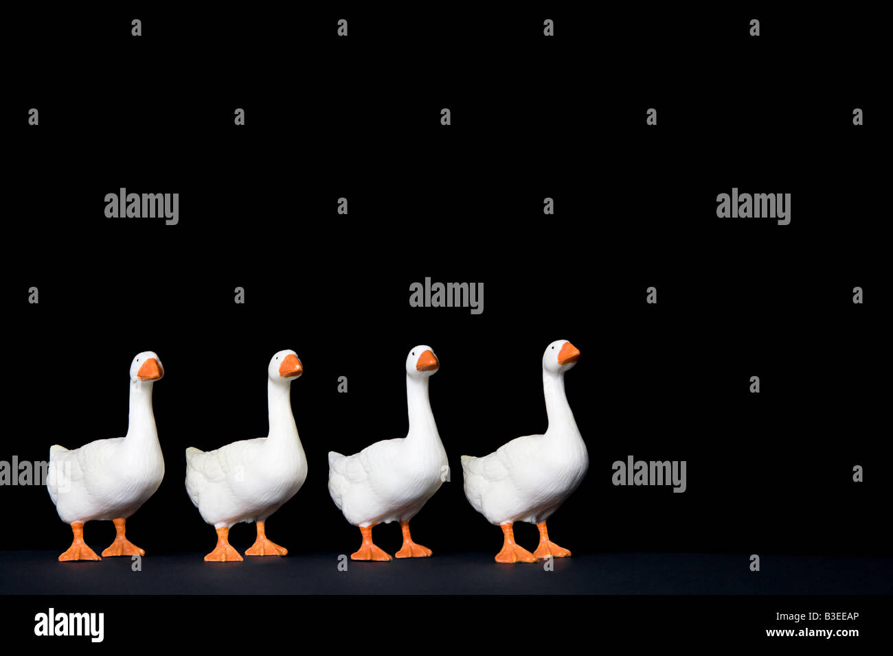 Four toy geese in a row Stock Photo