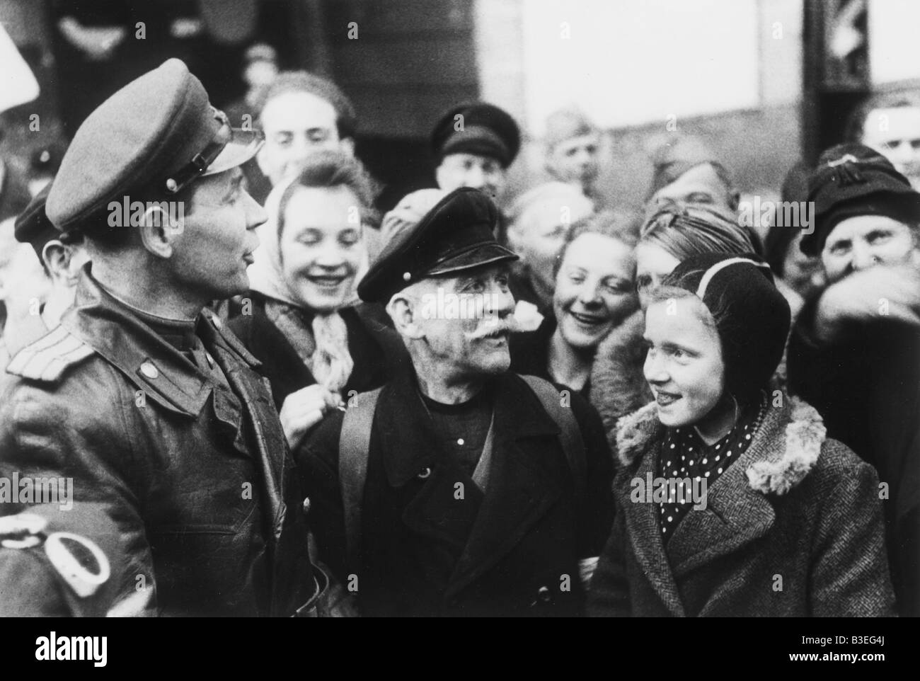 Soviet soldier with Berliners / 1945 Stock Photo