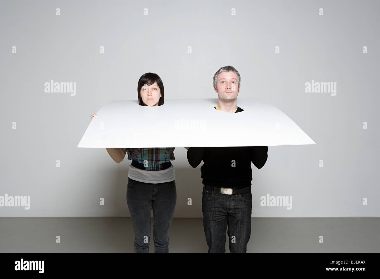 People with heads in board Stock Photo