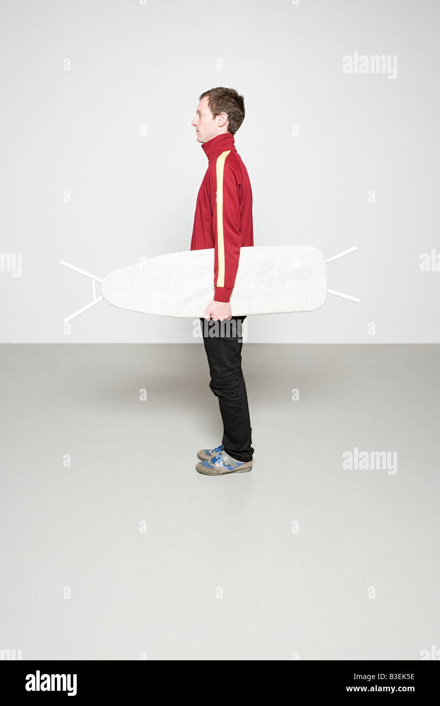 Man holding ironing board like hires stock photography and images Alamy