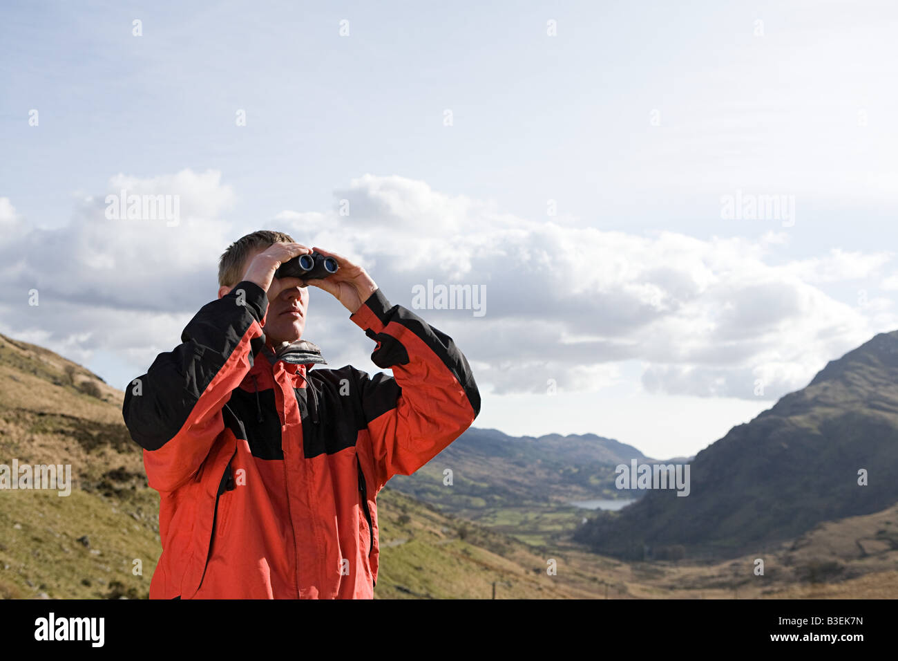 A man looking through binoculars Stock Photo