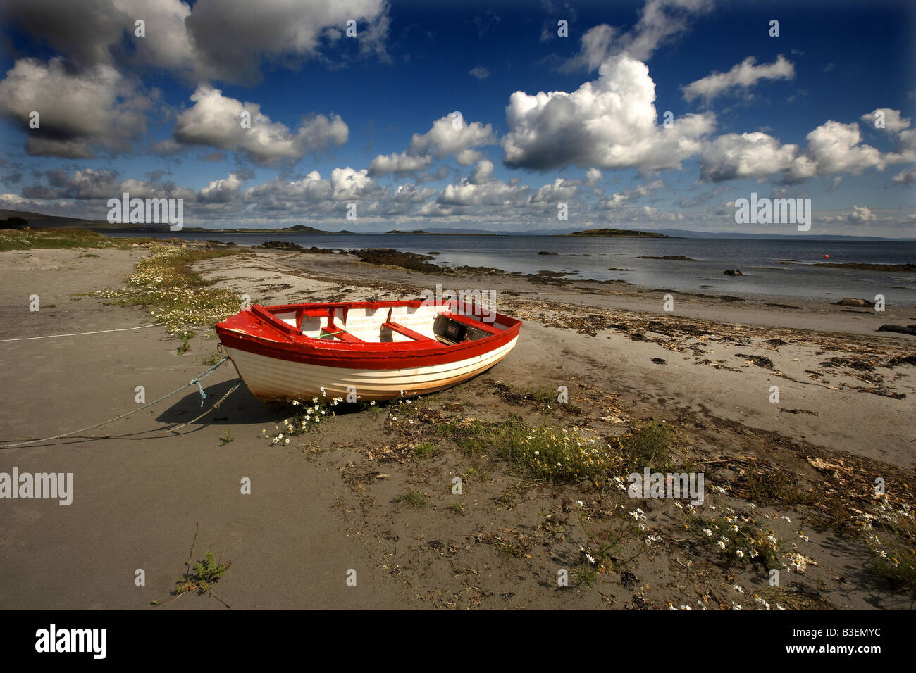 Traditional wooden painted fidhing boat on the beach at Craighouse Isle of Jura Inner Hebrides Scotland UK Stock Photo