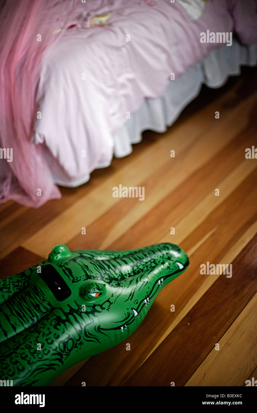 Inflatable crocodile series Lurking by a child s bed Stock Photo