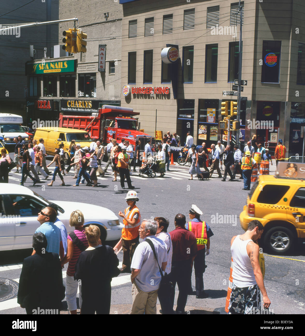 Pedestrians crossing the road at Liberty Street and Trinity Place close to Ground Zero, the new Freedom Tower site NY, June 2008 Stock Photo