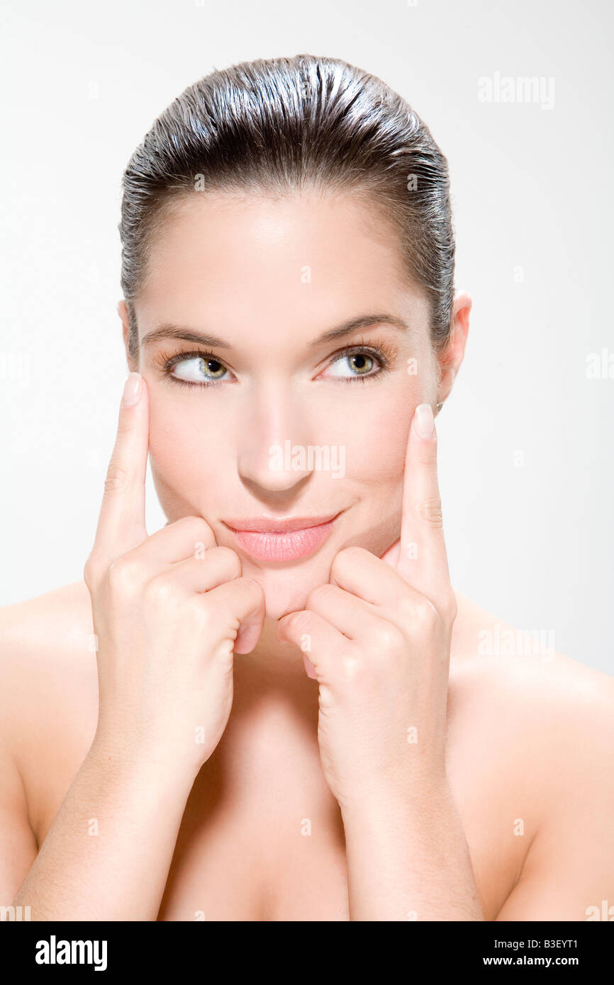 Young woman, hands to chin, portrait Stock Photo