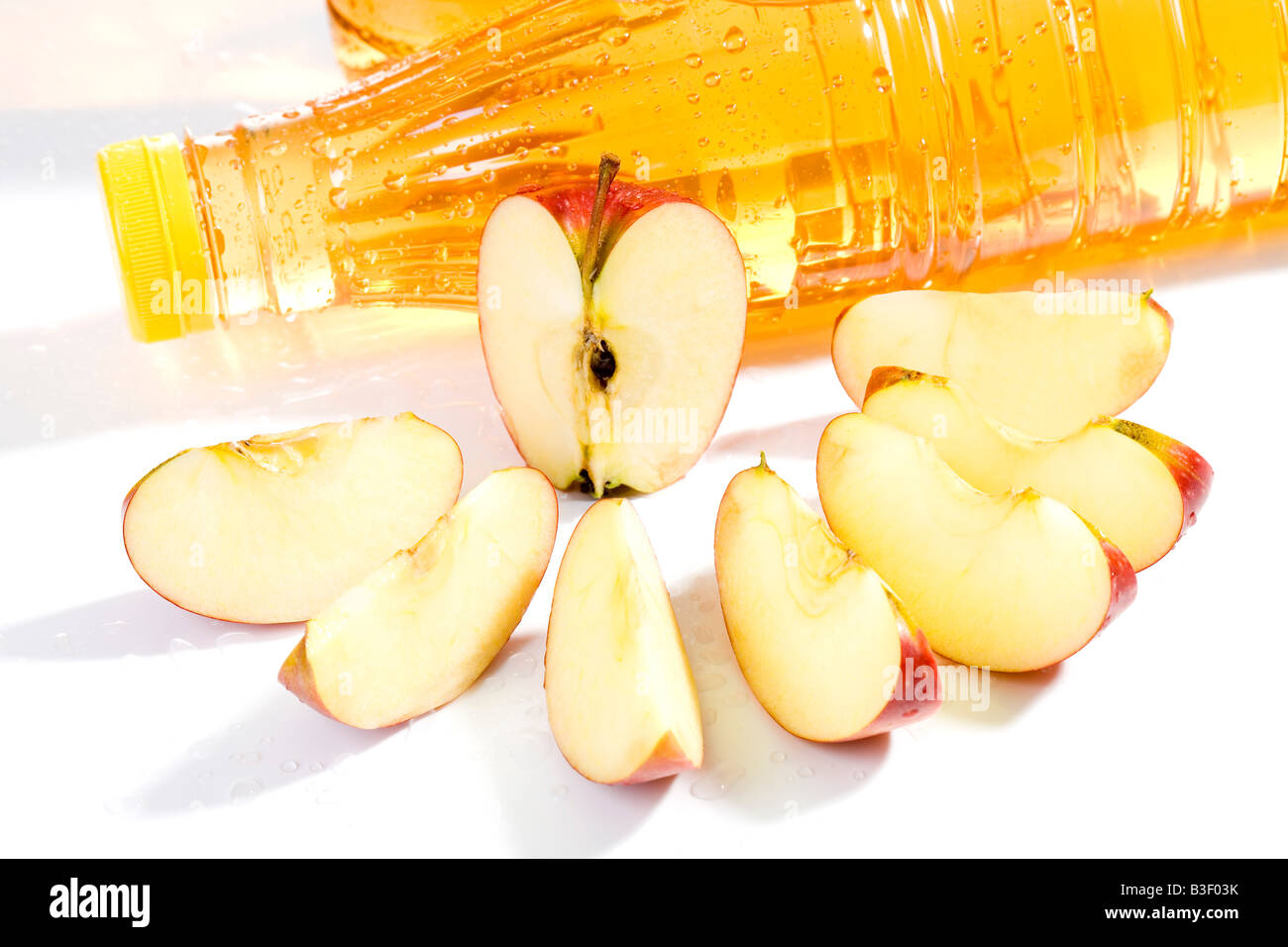 Apple slices and apple juice bottles, close up Stock Photo