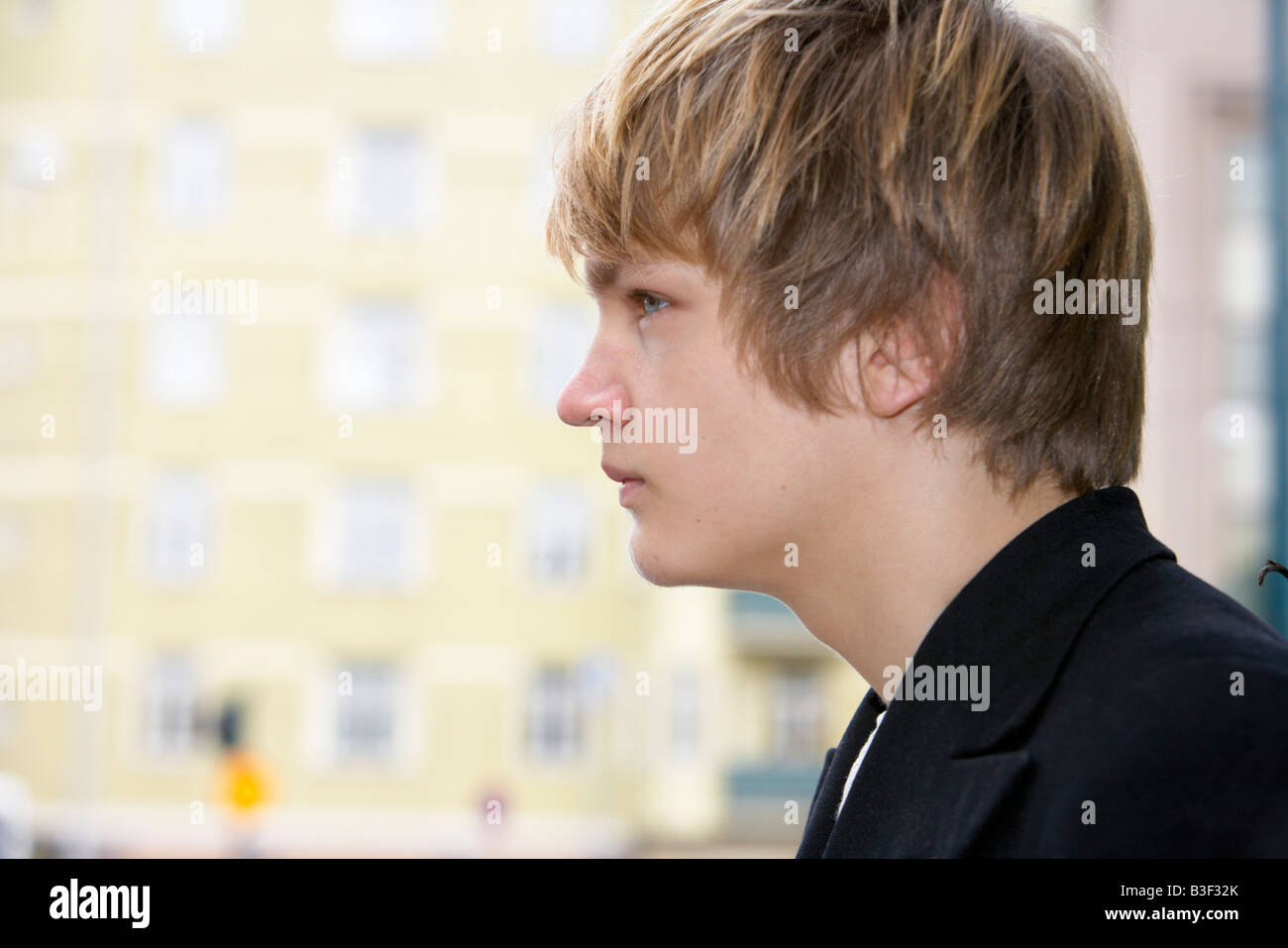 Teenage Boy Side Profile Building In Background Stock Photo Alamy