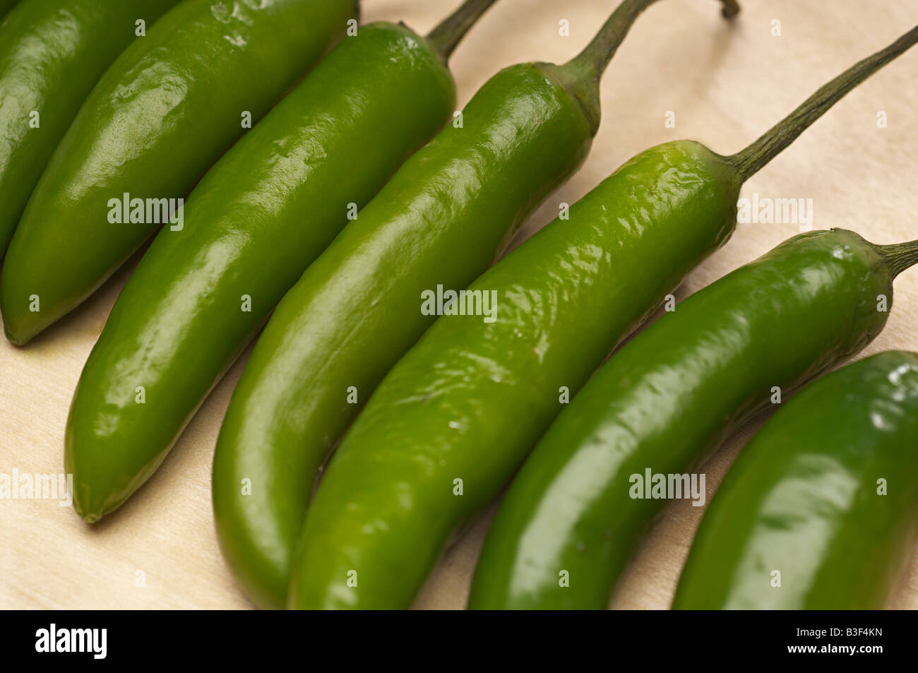 Green chili peppers in row, close-up Stock Photo - Alamy