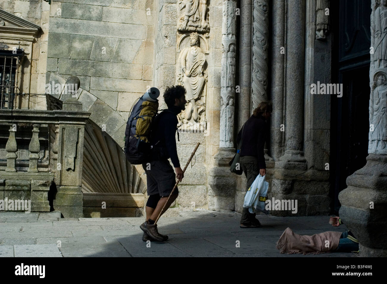 Pilgrims walk in Santiago de Compostela Cathedral WAY OF SAINT JAMES or CAMINO DE SANTIAGO in GALICIA region SPAIN Stock Photo