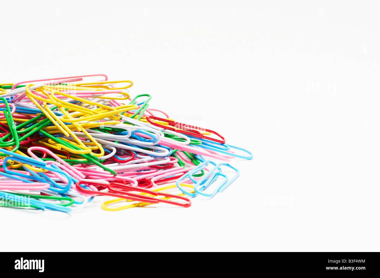 Heap of multi colored paper clips Stock Photo
