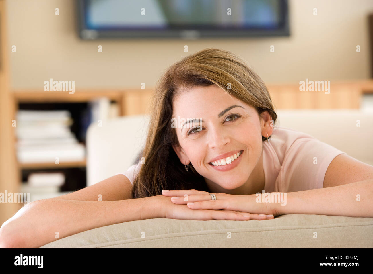 Woman lying in living room Stock Photo