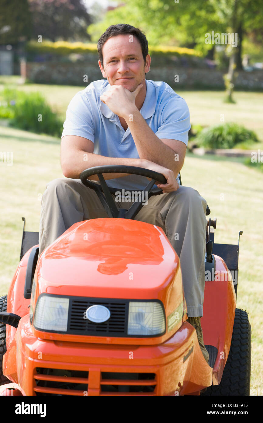 Man riding on lawnmower hi-res stock photography and images - Alamy