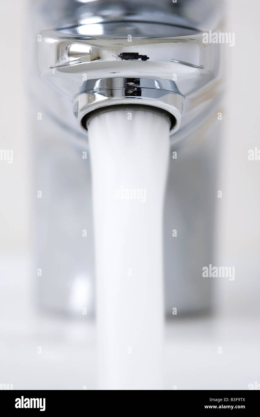 Water flowing out of a water tap Stock Photo