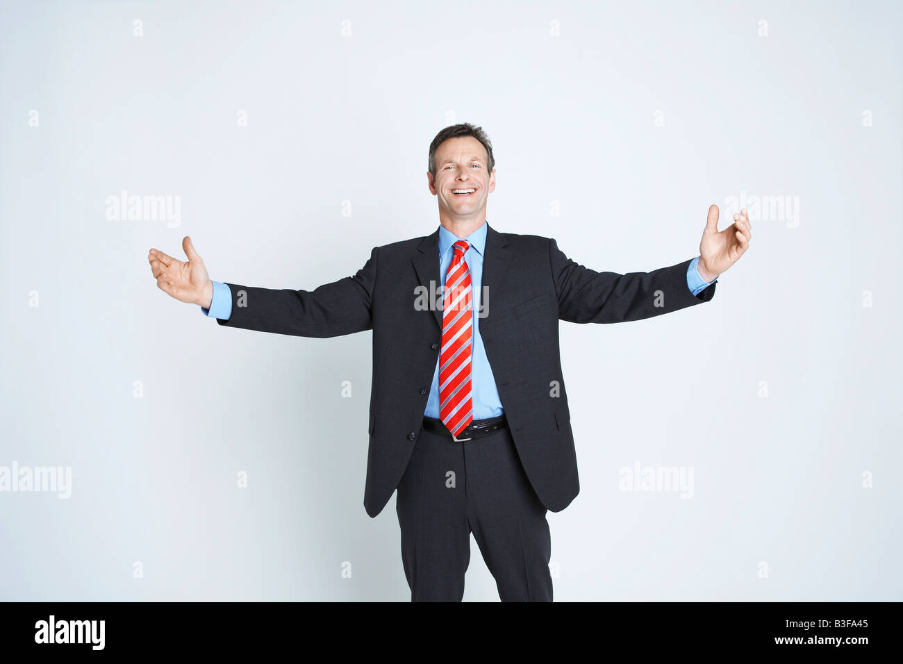 Studio portrait of businessman with arms outstretched Stock Photo