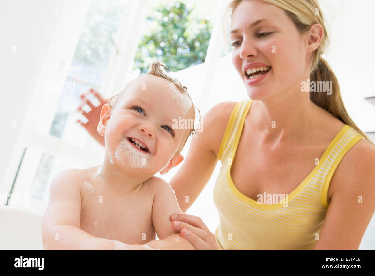 Mother giving baby bubble bath smiling Stock Photo Alamy