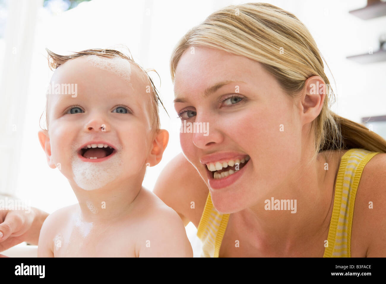 Mother giving baby bubble bath smiling Stock Photo Alamy